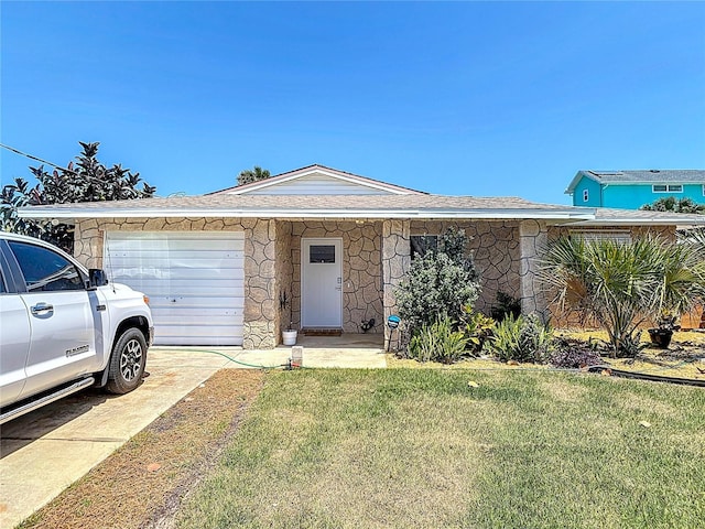 ranch-style home with roof with shingles, a front yard, stone siding, an attached garage, and concrete driveway