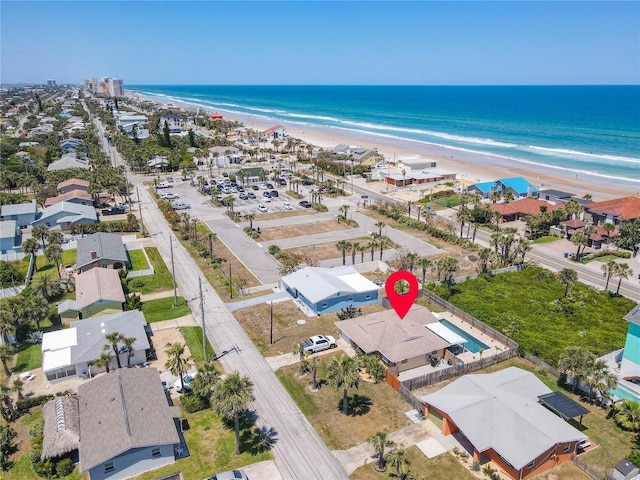 bird's eye view with a water view and a view of the beach
