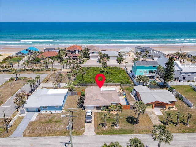 drone / aerial view featuring a view of the beach and a water view