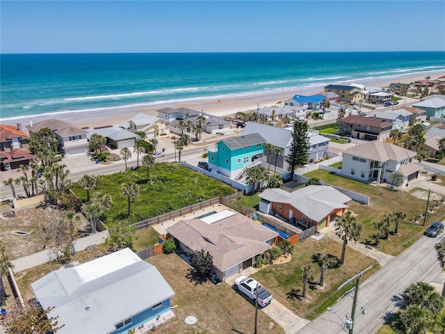drone / aerial view with a water view and a view of the beach