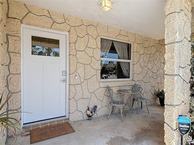 property entrance featuring a patio area