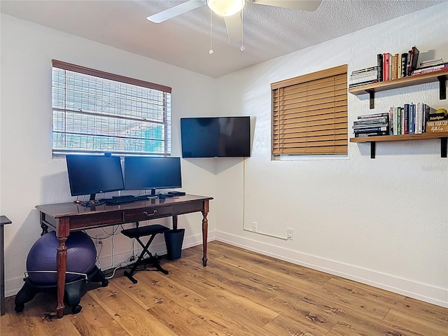 office with baseboards, a ceiling fan, and wood finished floors