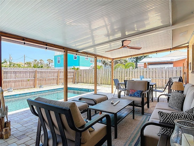 view of patio / terrace with a fenced backyard, outdoor lounge area, a fenced in pool, and ceiling fan