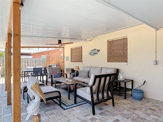 view of patio featuring an outdoor living space and fence