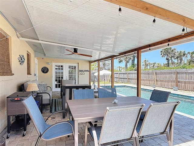 view of patio with outdoor dining space, a fenced in pool, french doors, a ceiling fan, and a fenced backyard