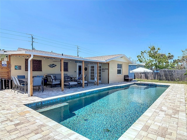 view of pool with a patio area, fence, an outdoor hangout area, french doors, and a fenced in pool