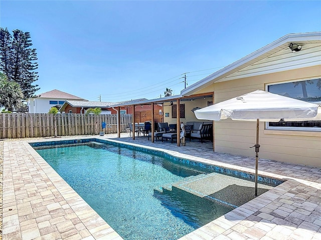 view of swimming pool featuring outdoor lounge area, a patio, a fenced in pool, and fence