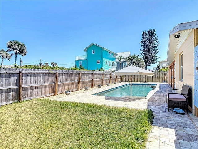 view of pool featuring a patio area, a fenced backyard, a fenced in pool, and a lawn