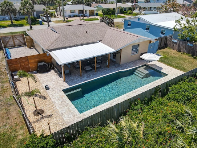 view of swimming pool with a fenced backyard, a patio, a residential view, a fenced in pool, and a gate