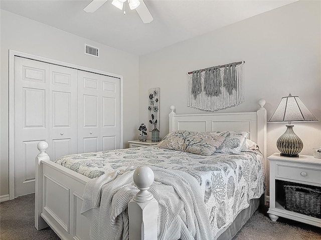 carpeted bedroom featuring a closet, a ceiling fan, and visible vents