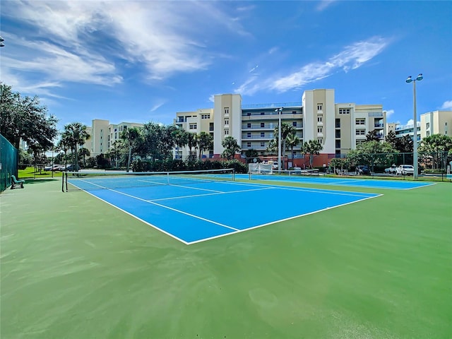 view of sport court featuring fence
