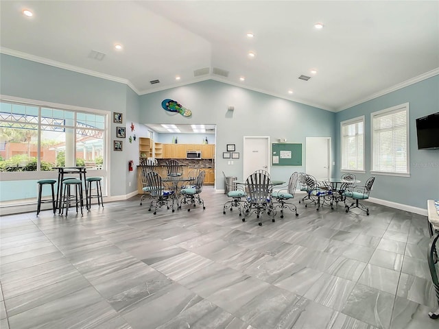 dining room featuring visible vents, crown molding, and baseboards