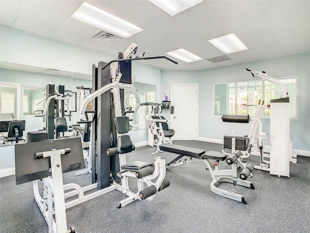 exercise room featuring baseboards and visible vents