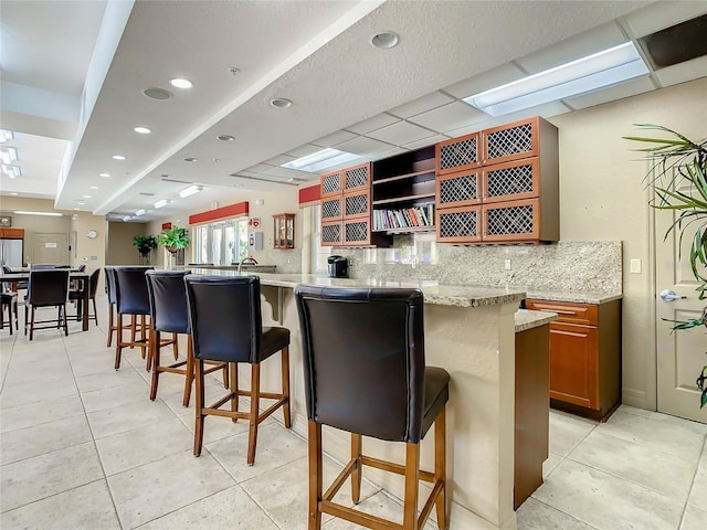 bar with light tile patterned flooring, tasteful backsplash, and recessed lighting