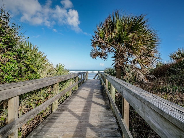view of home's community with a beach view and a water view