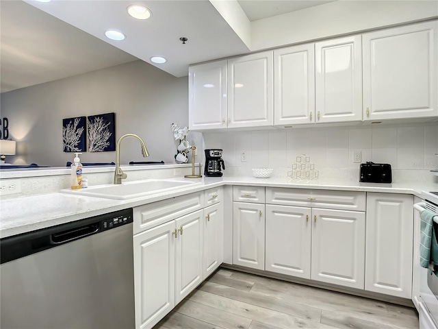 5300 S Atlantic Ave Unit 10-205, New Smyrna Beach, FL 32169 - kitchen with light countertops, stainless steel dishwasher, white cabinets, and a sink