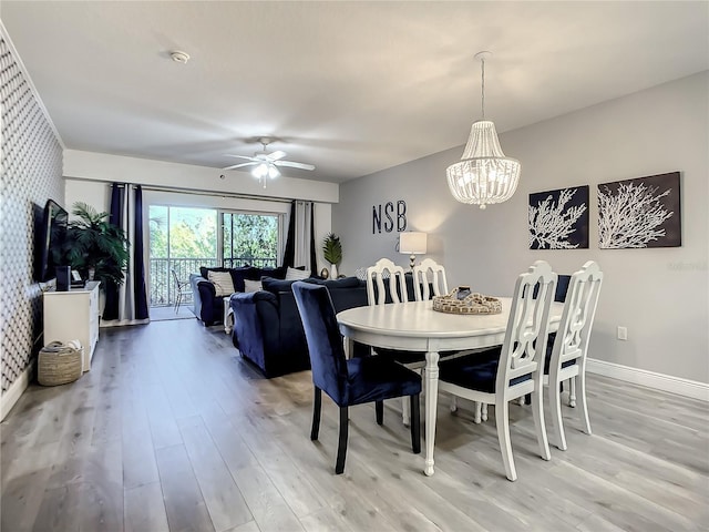 5300 S Atlantic Ave Unit 10-205, New Smyrna Beach, FL 32169 - dining room featuring baseboards, ceiling fan with notable chandelier, and light wood-style floors