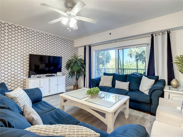 5300 S Atlantic Ave Unit 10-205, New Smyrna Beach, FL 32169 - living area with light wood finished floors, a ceiling fan, an accent wall, and wallpapered walls