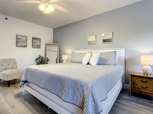 5300 S Atlantic Ave Unit 10-205, New Smyrna Beach, FL 32169 - bedroom featuring ceiling fan, wood finished floors, and baseboards