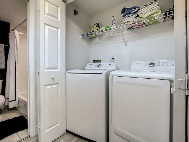 5300 S Atlantic Ave Unit 10-205, New Smyrna Beach, FL 32169 - laundry area featuring washing machine and clothes dryer and laundry area