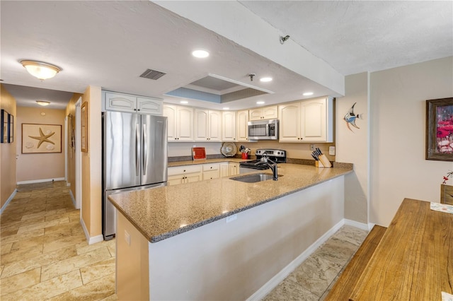 4139 S Atlantic Ave Unit A504, New Smyrna Beach, FL 32169 - kitchen featuring a peninsula, visible vents, baseboards, and stainless steel appliances