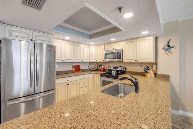 4139 S Atlantic Ave Unit A504, New Smyrna Beach, FL 32169 - kitchen featuring a sink, a tray ceiling, stainless steel appliances, visible vents, and recessed lighting