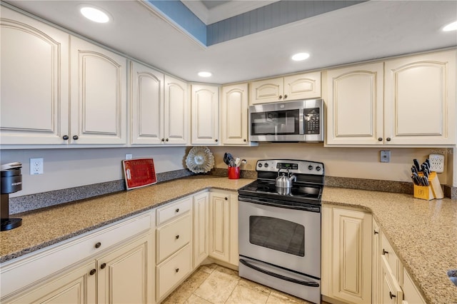 4139 S Atlantic Ave Unit A504, New Smyrna Beach, FL 32169 - kitchen featuring light stone countertops, stainless steel appliances, recessed lighting, and cream cabinets