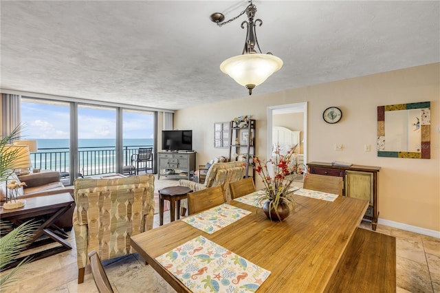 4139 S Atlantic Ave Unit A504, New Smyrna Beach, FL 32169 - dining space with baseboards and stone finish flooring