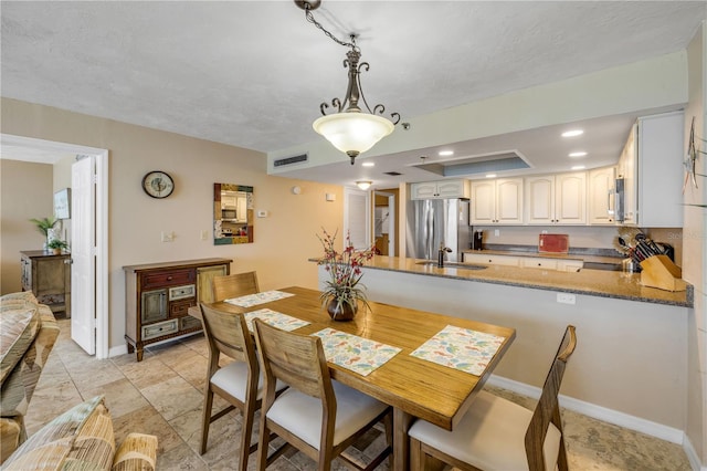 4139 S Atlantic Ave Unit A504, New Smyrna Beach, FL 32169 - dining space featuring baseboards, visible vents, and recessed lighting
