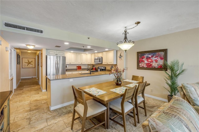 4139 S Atlantic Ave Unit A504, New Smyrna Beach, FL 32169 - dining space with recessed lighting, stone tile floors, visible vents, and baseboards