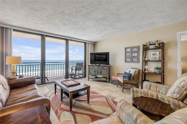 4139 S Atlantic Ave Unit A504, New Smyrna Beach, FL 32169 - living area featuring floor to ceiling windows, a healthy amount of sunlight, and stone finish flooring