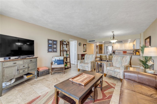 4139 S Atlantic Ave Unit A504, New Smyrna Beach, FL 32169 - living area with visible vents and a textured ceiling
