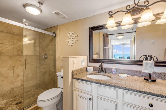 4139 S Atlantic Ave Unit A504, New Smyrna Beach, FL 32169 - bathroom featuring toilet, vanity, visible vents, and a stall shower