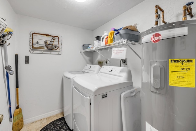 4139 S Atlantic Ave Unit A504, New Smyrna Beach, FL 32169 - laundry room with separate washer and dryer, baseboards, water heater, and laundry area