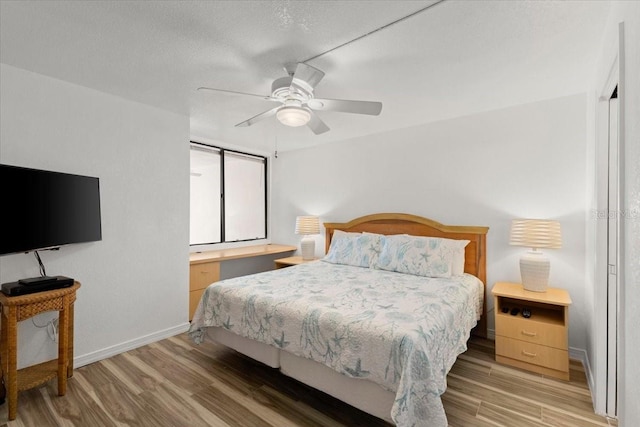 5201 S Atlantic Ave Unit 708A, New Smyrna Beach, FL 32169 - bedroom with wood finished floors, baseboards, and ceiling fan