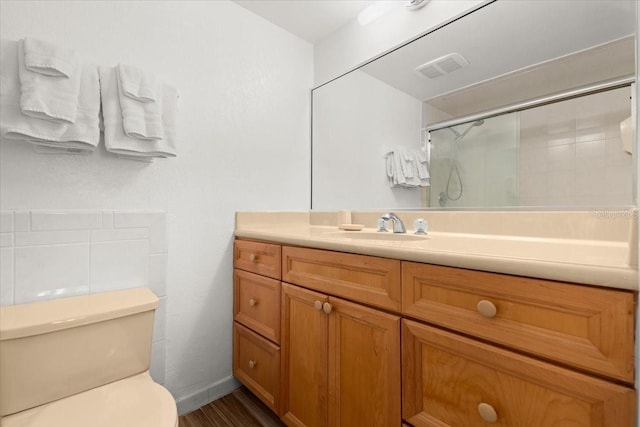 5201 S Atlantic Ave Unit 708A, New Smyrna Beach, FL 32169 - full bath featuring a stall shower, toilet, vanity, and wood finished floors