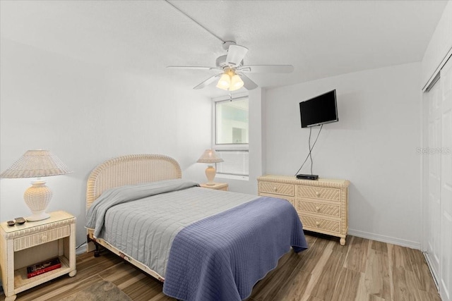 5201 S Atlantic Ave Unit 708A, New Smyrna Beach, FL 32169 - bedroom with wood finished floors, a closet, a ceiling fan, and baseboards