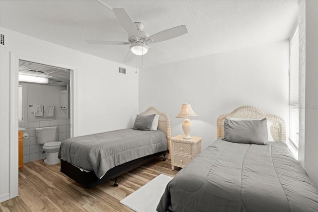5201 S Atlantic Ave Unit 708A, New Smyrna Beach, FL 32169 - bedroom featuring light wood-style floors, ensuite bathroom, and a ceiling fan