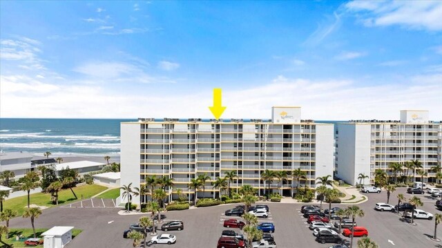 5201 S Atlantic Ave Unit 708A, New Smyrna Beach, FL 32169 - view of apartment building / complex featuring a water view and uncovered parking