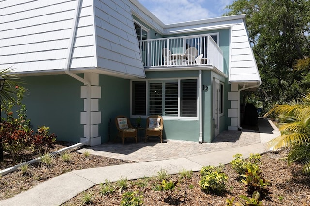 4150 S Atlantic Ave Unit 115D, New Smyrna Beach, FL 32169 - view of property exterior with a patio area and a balcony