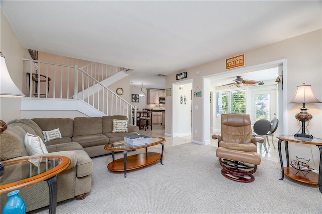 4150 S Atlantic Ave Unit 115D, New Smyrna Beach, FL 32169 - living room featuring stairway, carpet flooring, and a ceiling fan
