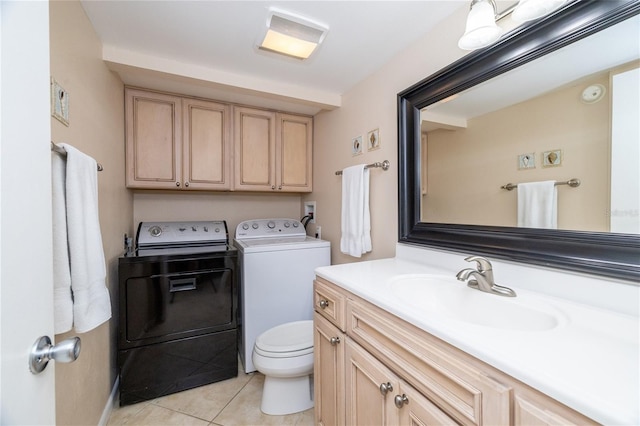 4150 S Atlantic Ave Unit 115D, New Smyrna Beach, FL 32169 - bathroom featuring separate washer and dryer, tile patterned floors, vanity, and toilet