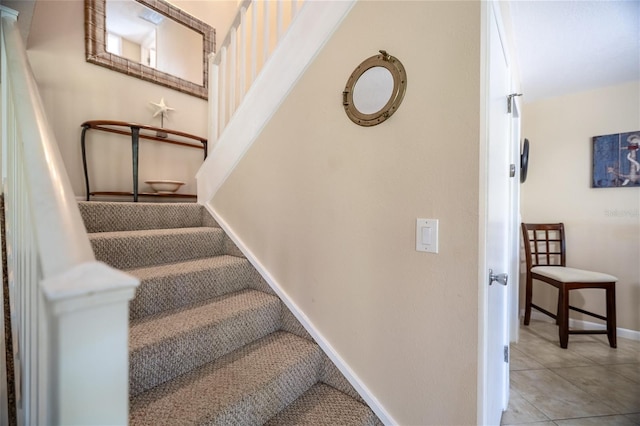 4150 S Atlantic Ave Unit 115D, New Smyrna Beach, FL 32169 - stairs featuring baseboards and tile patterned flooring