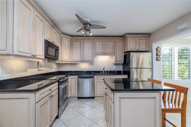 4150 S Atlantic Ave Unit 115D, New Smyrna Beach, FL 32169 - kitchen with dark countertops, a sink, appliances with stainless steel finishes, and ceiling fan