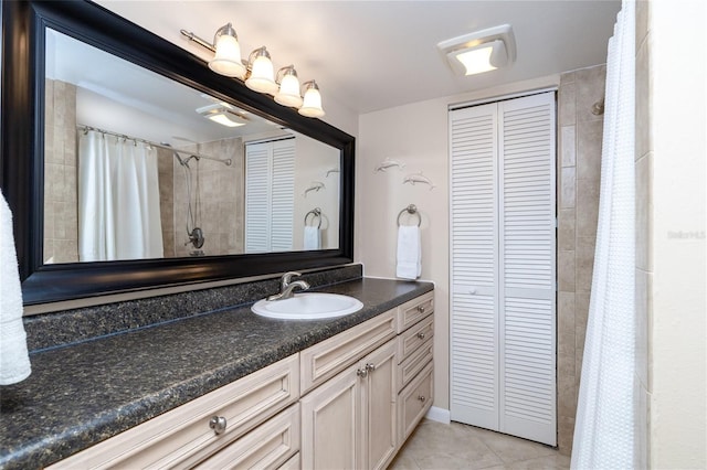 4150 S Atlantic Ave Unit 115D, New Smyrna Beach, FL 32169 - bathroom featuring a shower with shower curtain, a closet, tile patterned flooring, and vanity
