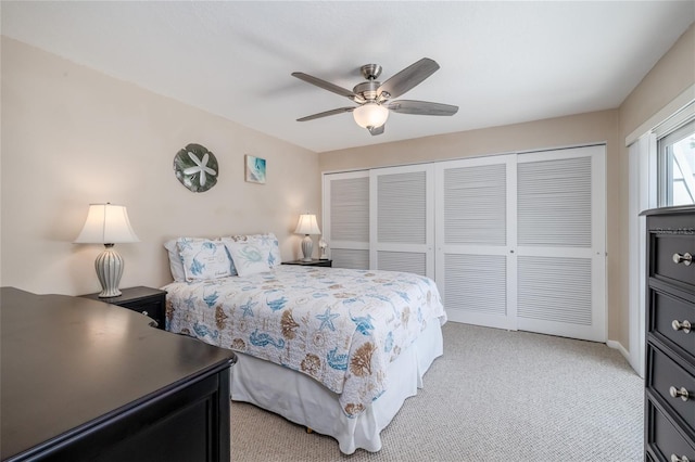 4150 S Atlantic Ave Unit 115D, New Smyrna Beach, FL 32169 - bedroom with light carpet, a ceiling fan, and a closet