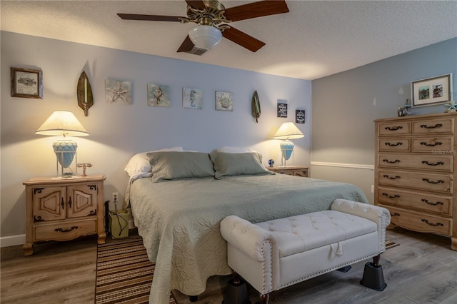 2204 Kumquat Dr, Edgewater, FL 32141 - bedroom with a textured ceiling, a ceiling fan, baseboards, wood finished floors, and visible vents