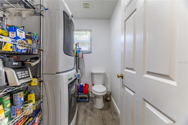 2204 Kumquat Dr, Edgewater, FL 32141 - laundry area featuring laundry area, baseboards, wood finished floors, visible vents, and stacked washer and clothes dryer