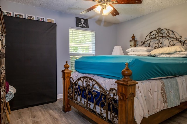 2204 Kumquat Dr, Edgewater, FL 32141 - bedroom with a ceiling fan, a textured ceiling, and wood finished floors
