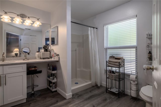 2204 Kumquat Dr, Edgewater, FL 32141 - full bathroom with a stall shower, wood finished floors, a healthy amount of sunlight, and toilet